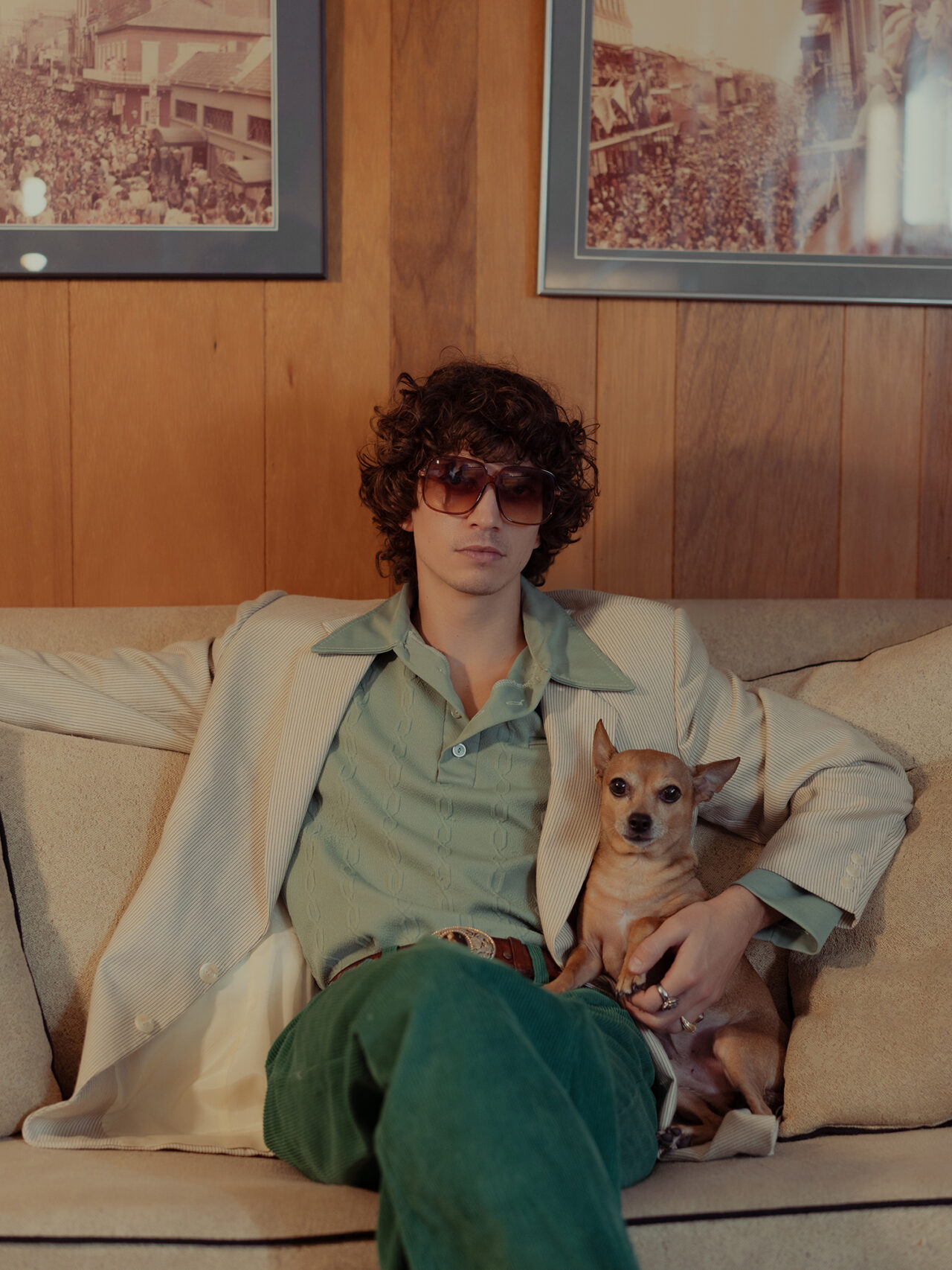 1970s vibes. a man sitting with his dog